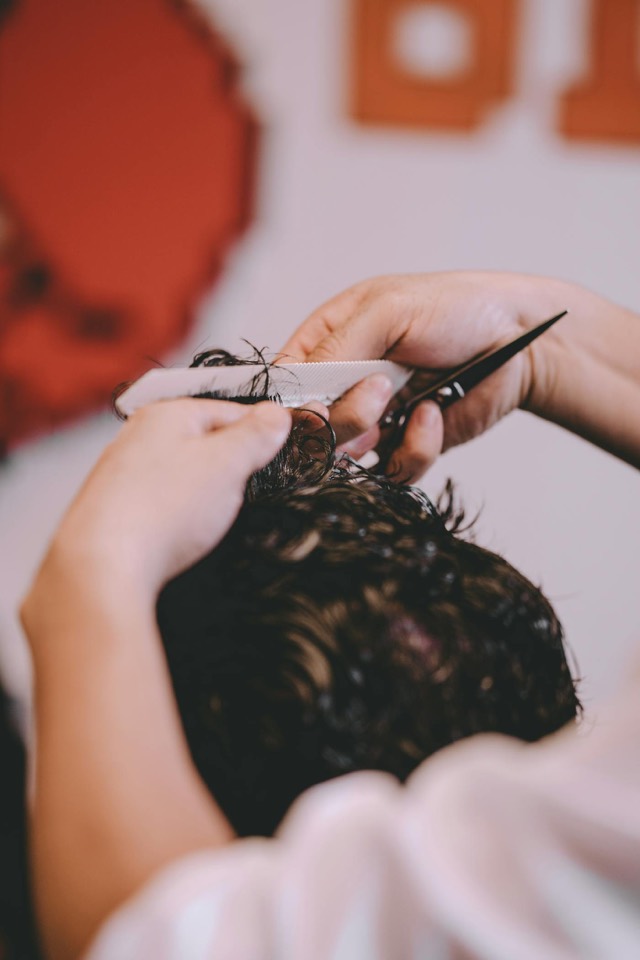 Barber using scissors for a classic men's haircut